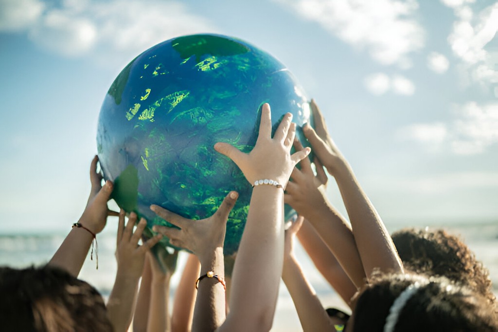 Hands lifting a globe together